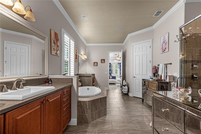 full bath featuring a stall shower, visible vents, a garden tub, crown molding, and a sink