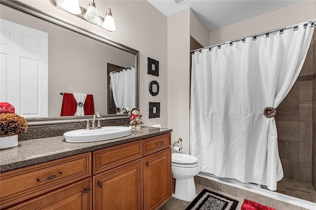 bathroom with tile patterned flooring, a shower with shower curtain, vanity, and toilet