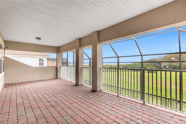 view of patio featuring a lanai