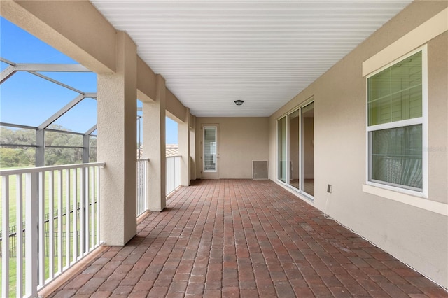 view of patio / terrace featuring glass enclosure