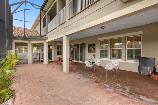 view of patio / terrace featuring glass enclosure