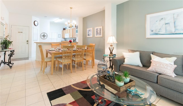 living room featuring light tile patterned flooring and a chandelier