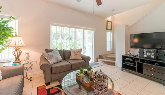 living room with light tile patterned floors, ceiling fan, and lofted ceiling