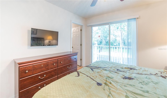 bedroom with a textured ceiling, access to outside, and ceiling fan