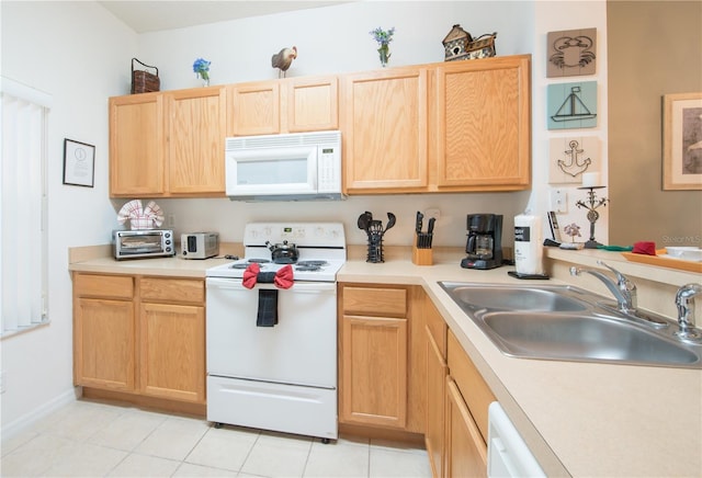 kitchen with light brown cabinets, white appliances, light tile patterned floors, and sink