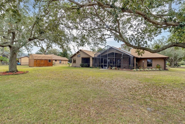 exterior space with a lanai, a storage unit, and a yard