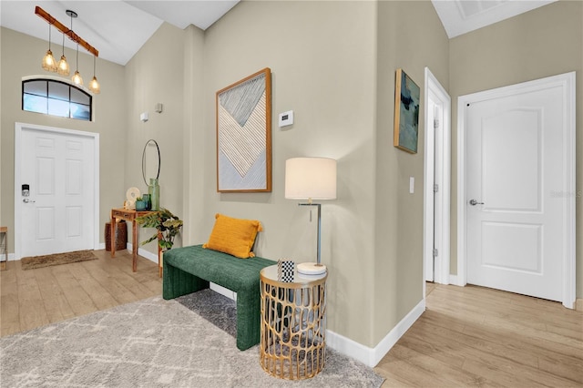 entryway featuring an inviting chandelier and light hardwood / wood-style flooring