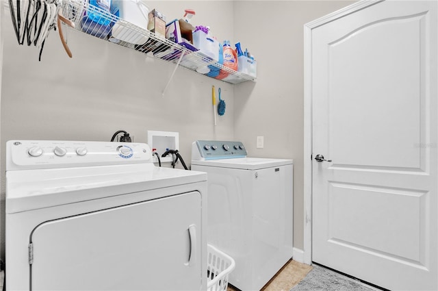 clothes washing area with washing machine and clothes dryer