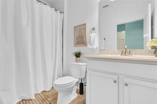 bathroom featuring vanity, tile patterned floors, and toilet