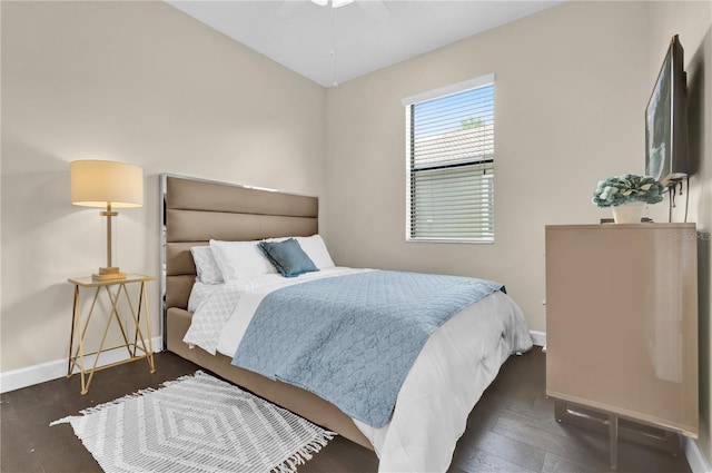 bedroom with dark hardwood / wood-style flooring and ceiling fan