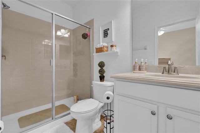 bathroom featuring an enclosed shower, vanity, and toilet