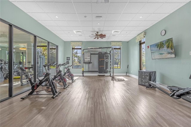 workout area featuring wood-type flooring and a drop ceiling