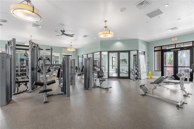 workout area featuring french doors and a textured ceiling