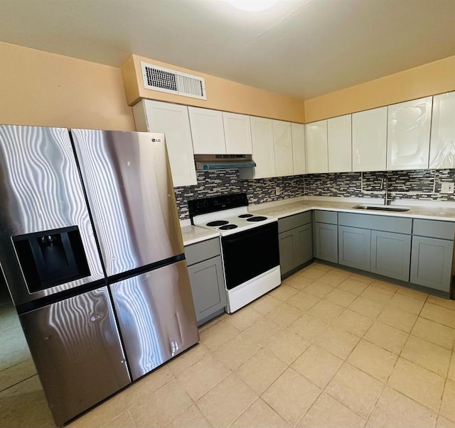 kitchen with electric stove, sink, gray cabinetry, and stainless steel fridge