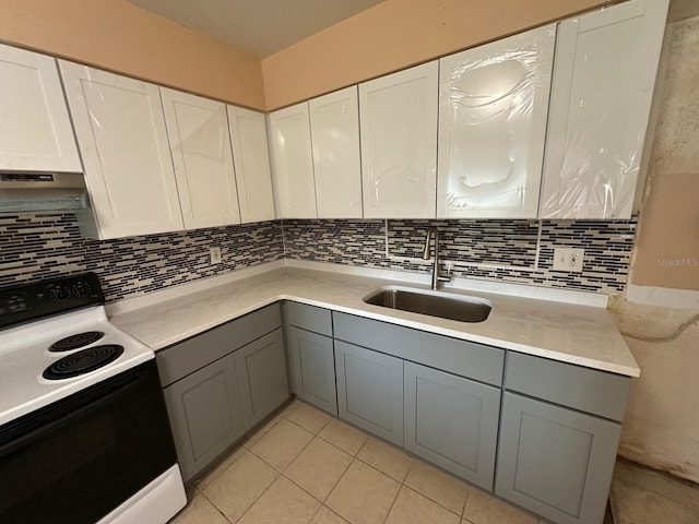 kitchen featuring gray cabinets, range with electric stovetop, and white cabinetry