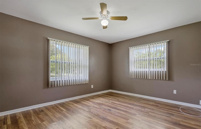 empty room featuring hardwood / wood-style flooring and ceiling fan