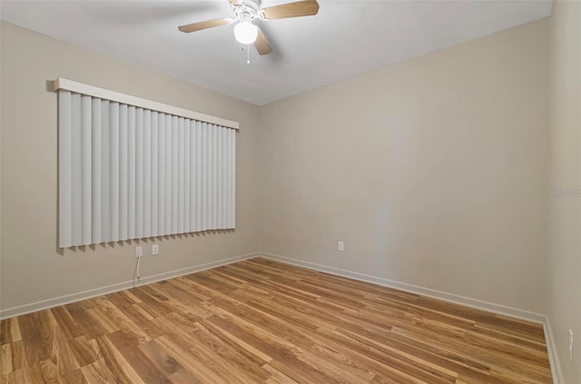 spare room with hardwood / wood-style flooring and ceiling fan