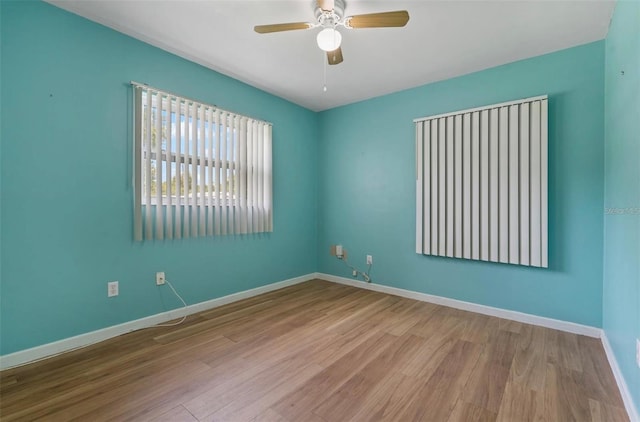 spare room featuring light wood-type flooring and ceiling fan