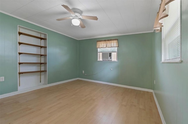 spare room featuring light wood-type flooring, cooling unit, crown molding, and ceiling fan