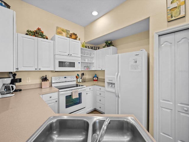 kitchen with white appliances and white cabinets