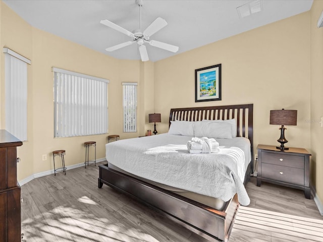 bedroom with ceiling fan and light hardwood / wood-style floors