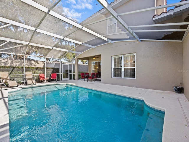 view of pool featuring a patio and glass enclosure