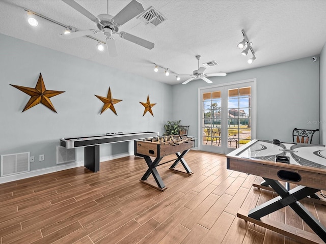 playroom featuring a textured ceiling and ceiling fan