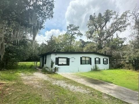 10628 Wake Forest Ave, Jacksonville, FL 32218 - view of property exterior with a lawn