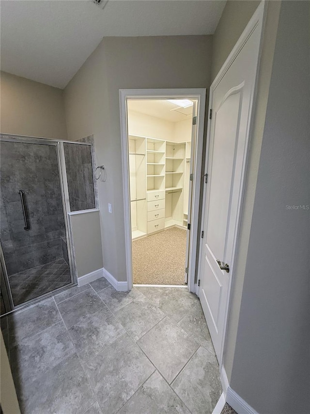 bathroom featuring walk in shower and built in shelves