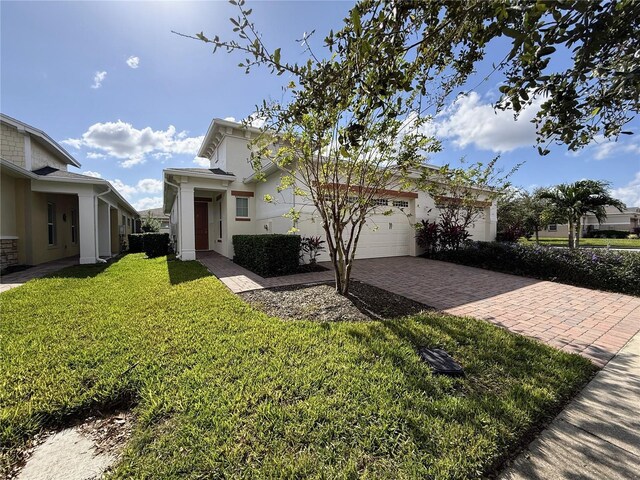 view of front of house with a garage and a front yard