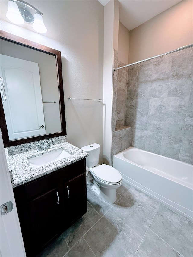 full bathroom featuring toilet, tiled shower / bath, and vanity