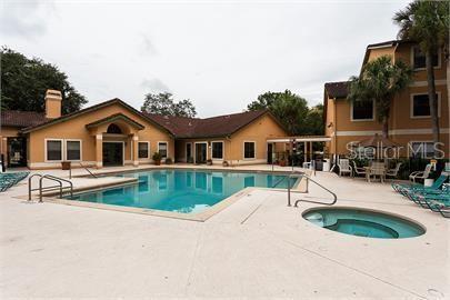 pool with a community hot tub and a patio area