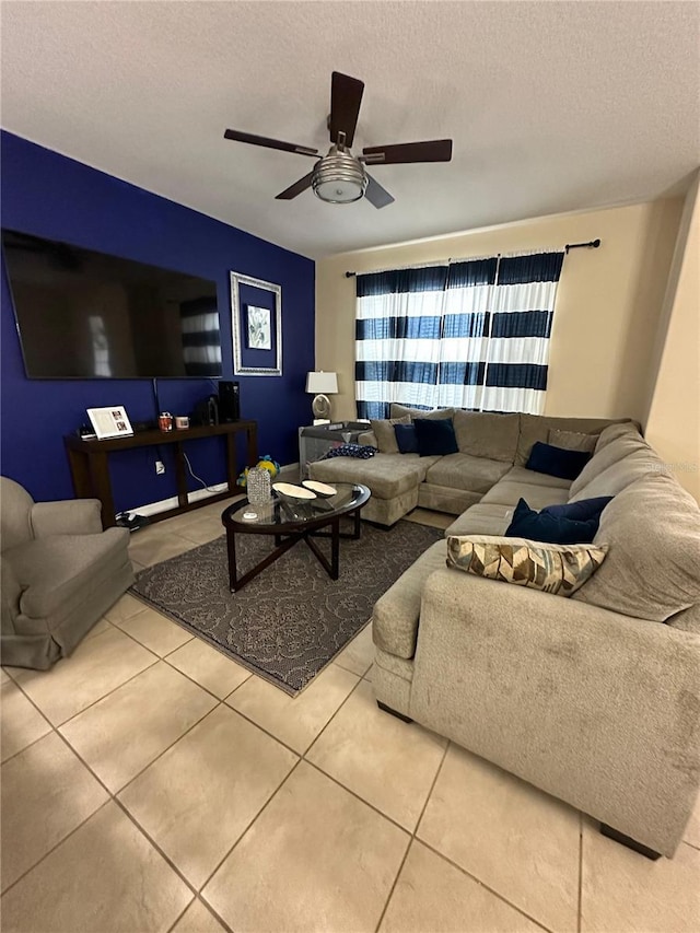 living room featuring light tile patterned floors, a textured ceiling, and ceiling fan