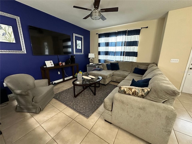 living room with ceiling fan and light tile patterned flooring