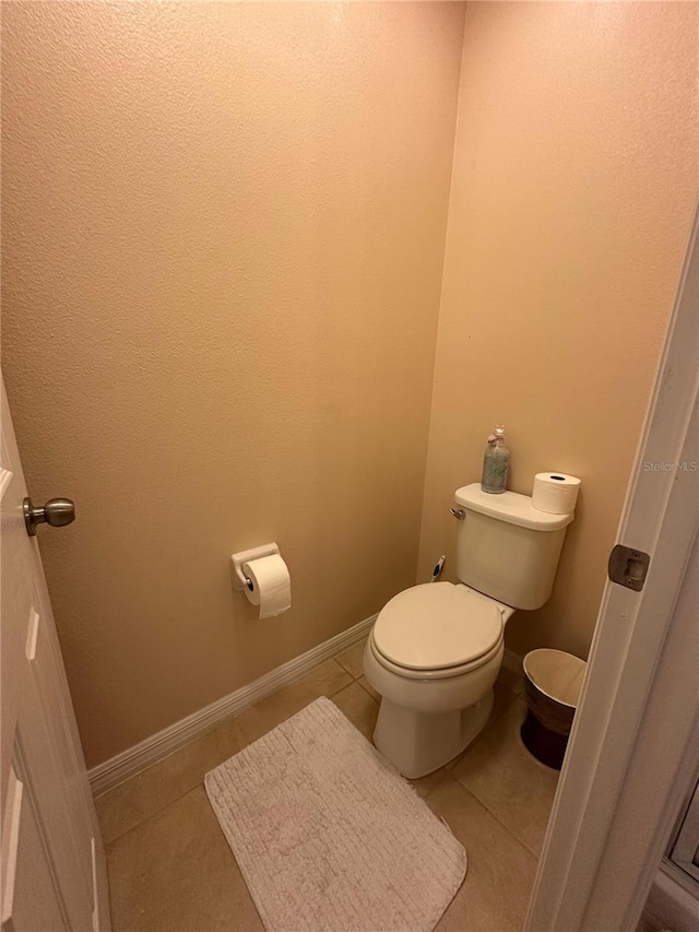 bathroom featuring tile patterned floors and toilet