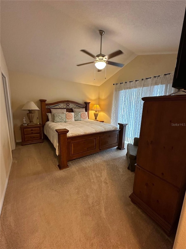 carpeted bedroom with ceiling fan, lofted ceiling, and a textured ceiling