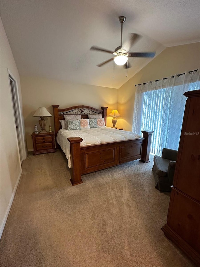 bedroom featuring carpet floors, vaulted ceiling, and ceiling fan