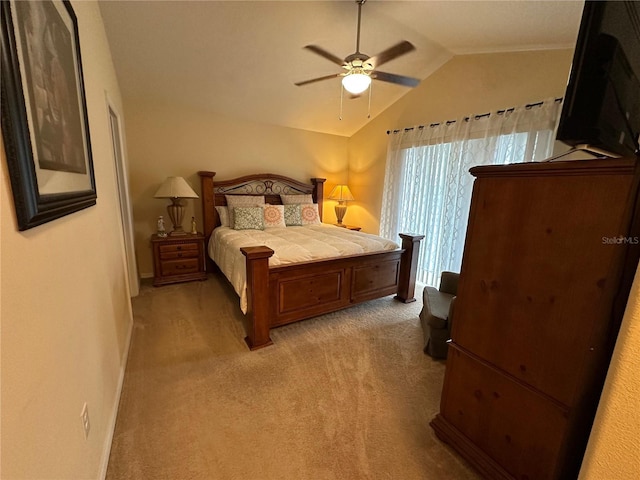 carpeted bedroom with ceiling fan and lofted ceiling