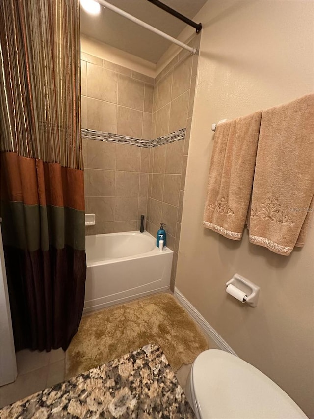 bathroom with tile patterned floors, shower / bath combo, and toilet