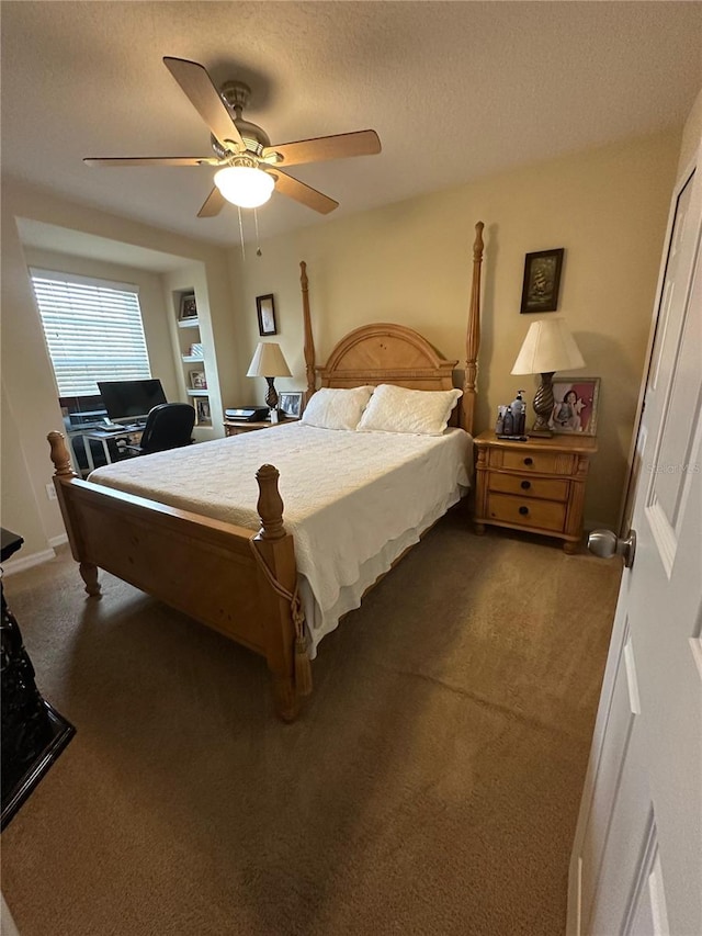 carpeted bedroom with ceiling fan and a textured ceiling