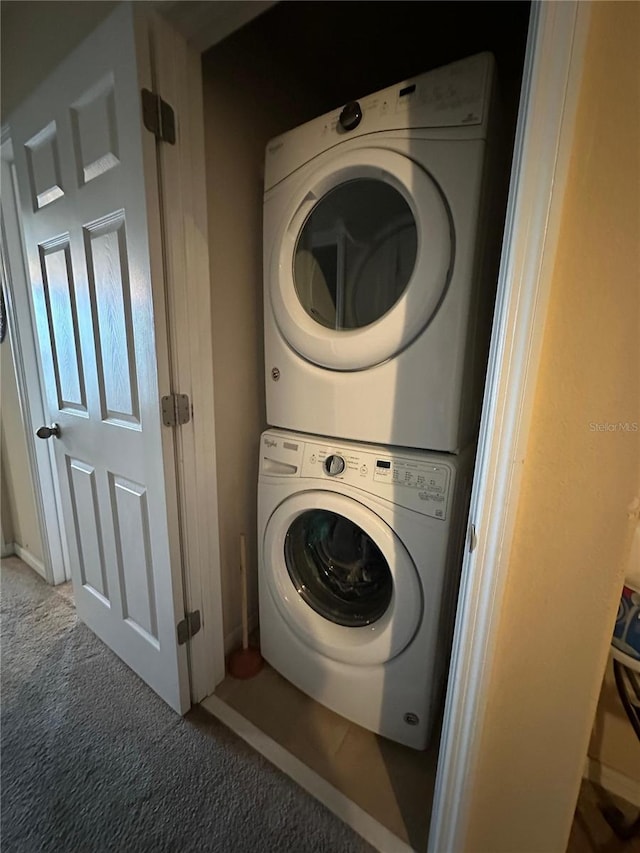 washroom featuring carpet and stacked washer and dryer