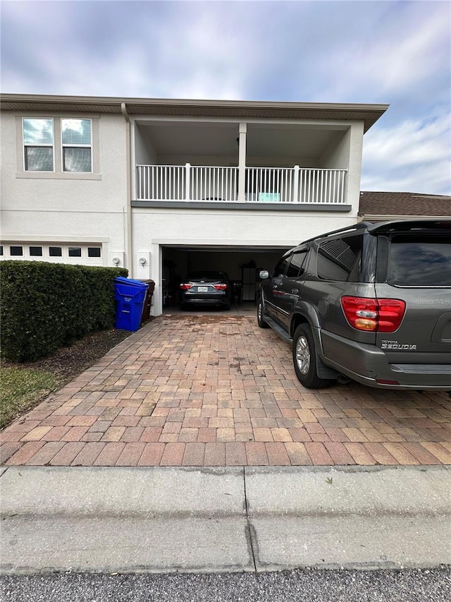 view of front facade featuring a balcony and a garage