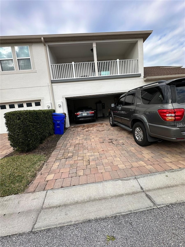 view of front of home featuring a balcony and a garage