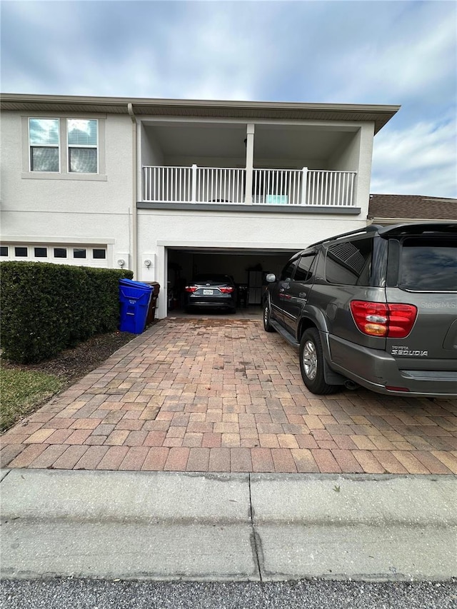 view of front of property with a garage and a balcony