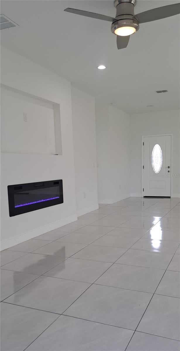 unfurnished living room featuring light tile patterned flooring