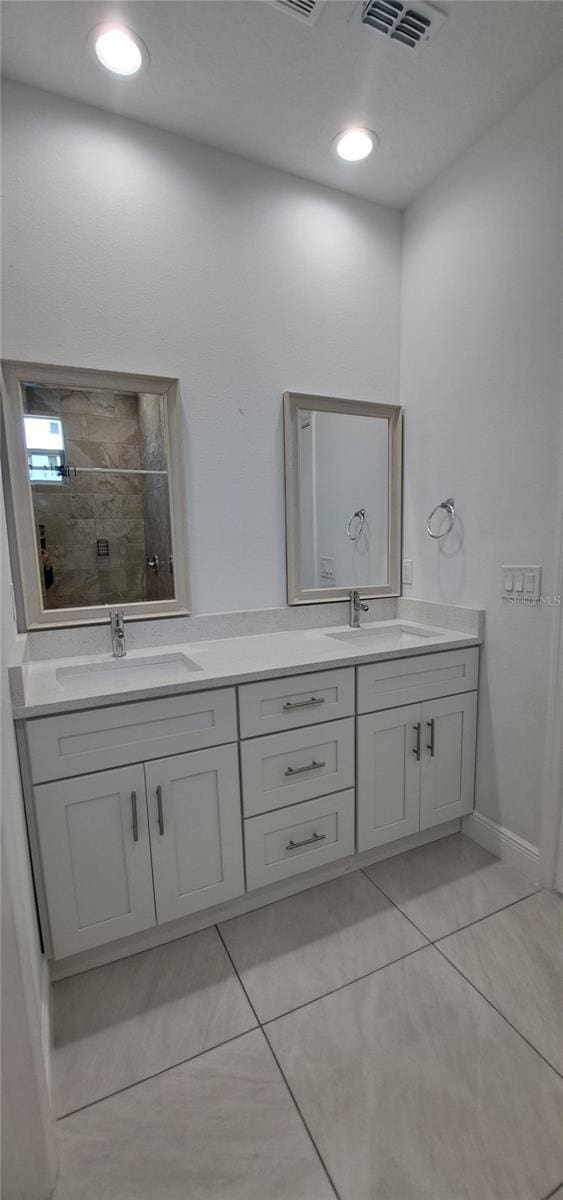 bathroom with vanity and tile patterned flooring