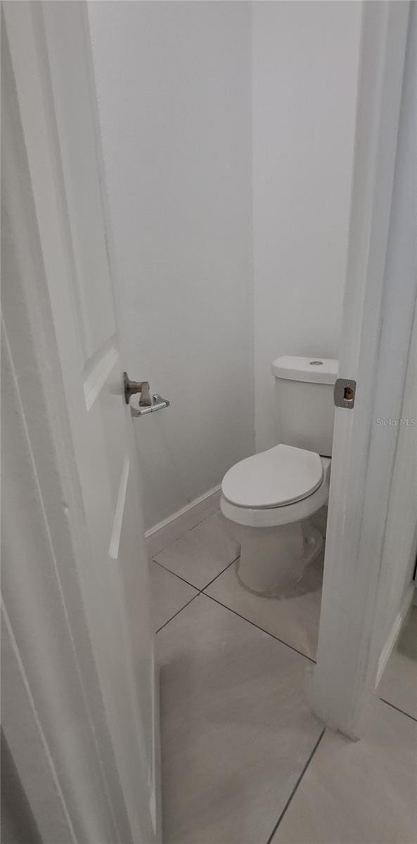 bathroom with tile patterned floors and toilet