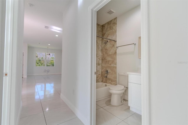 full bathroom featuring vanity, tiled shower / bath, tile patterned floors, and toilet