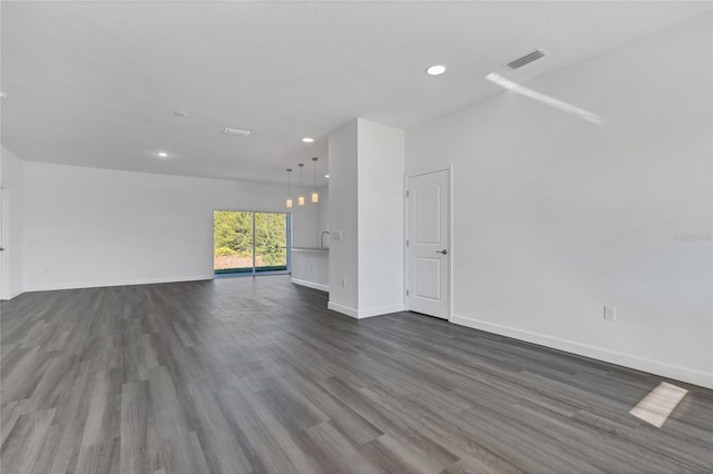 unfurnished living room featuring dark wood-type flooring