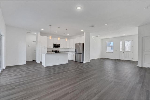 unfurnished living room featuring dark hardwood / wood-style flooring